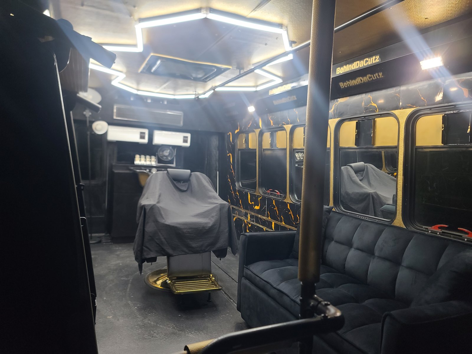 Barber chair and lounge seating inside the mobile shop